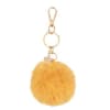 Porta-chaves com pompom em imitação de pelo amarelo e berloques dourados