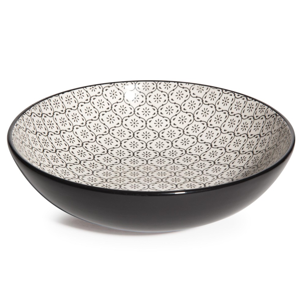 Assiette creuse en faïence à motifs noirs