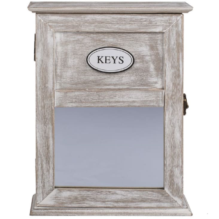 Une petite boite à clé tout en bois avec sur la porte une déco miroir.