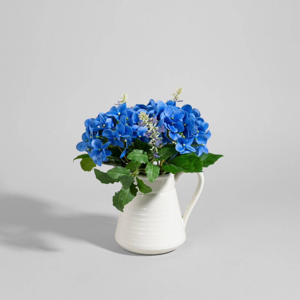 Bouquet de fleurs artificielles bleues et pot en grès