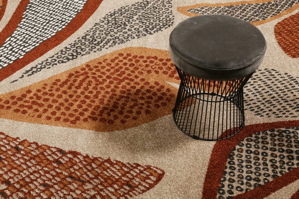 Tapis design motif végétal fond beige sable 133x200