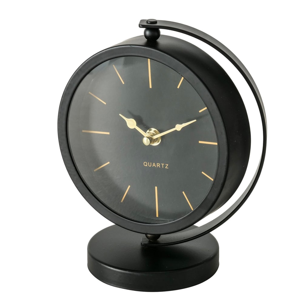 WADIGA Horloge ronde à poser en métal noir et doré. Dimensions: hauteur 20cm x Longueur 16cm x largeur 10cm Couleur: Noir et doré Matière: Métal