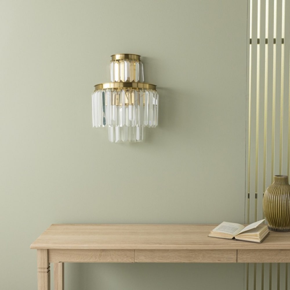 SIGNATURE Produkteigenschaften: Struktur aus goldenem Metall. Anhänger aus facettiertem Glas. Art-Déco-Stil. Gold