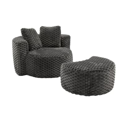 Fauteuil géant gris foncé en fausse fourrure avec pouf